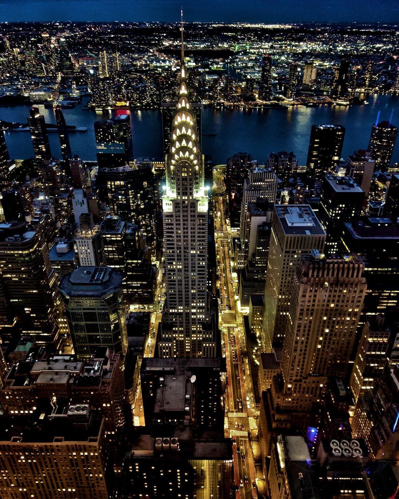 The Chrysler Building lit at night, seen from above