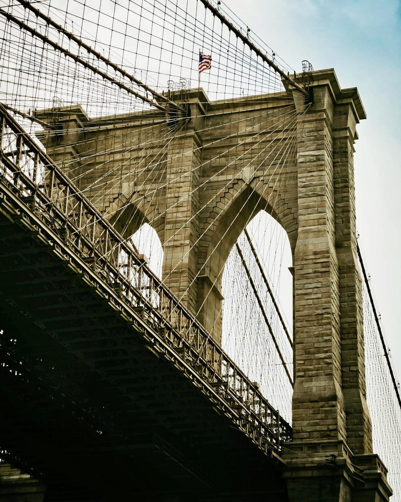 The stone arches and cables of the Brooklyn Bridge