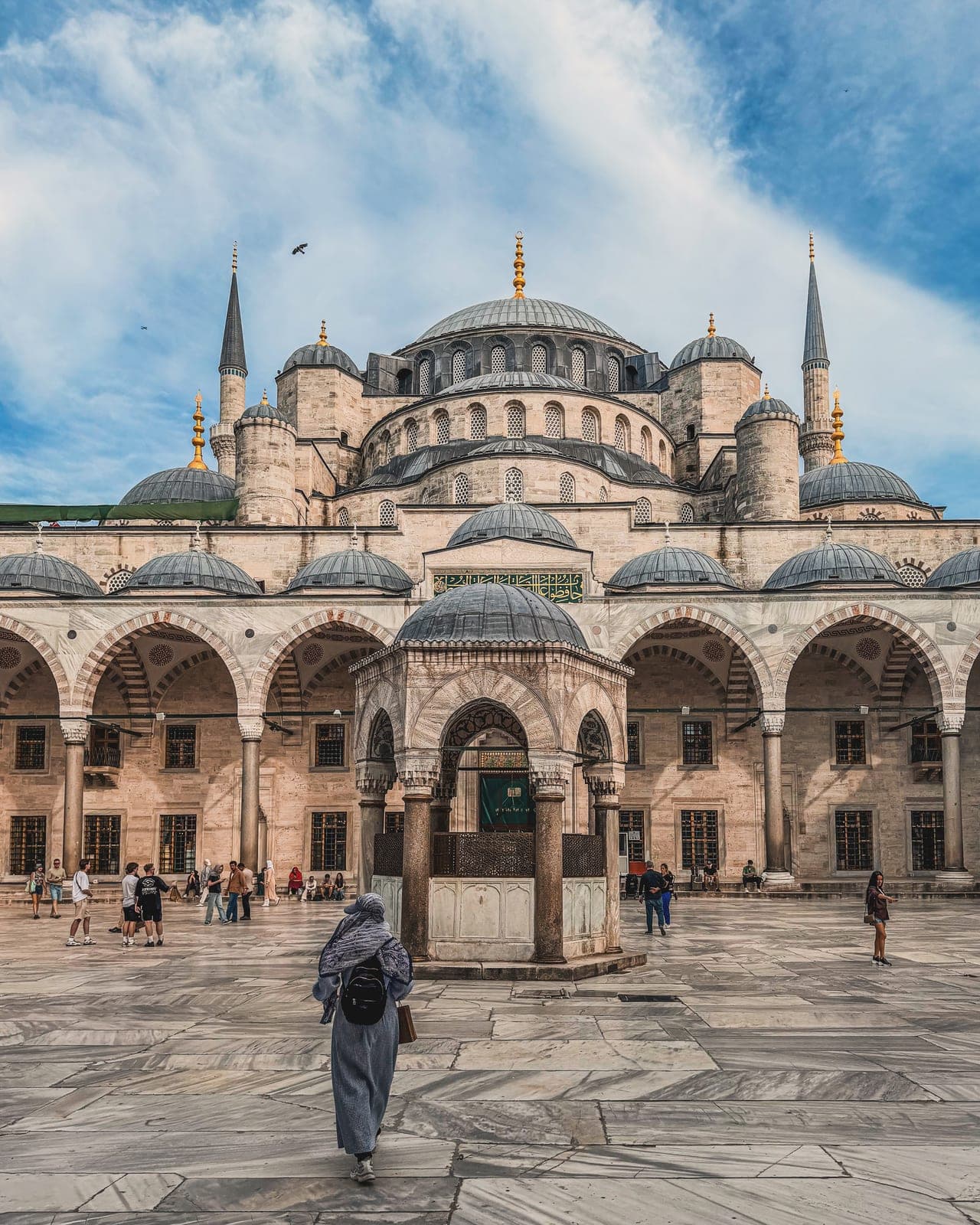 A mosque courtyard and arcade under blue sky
