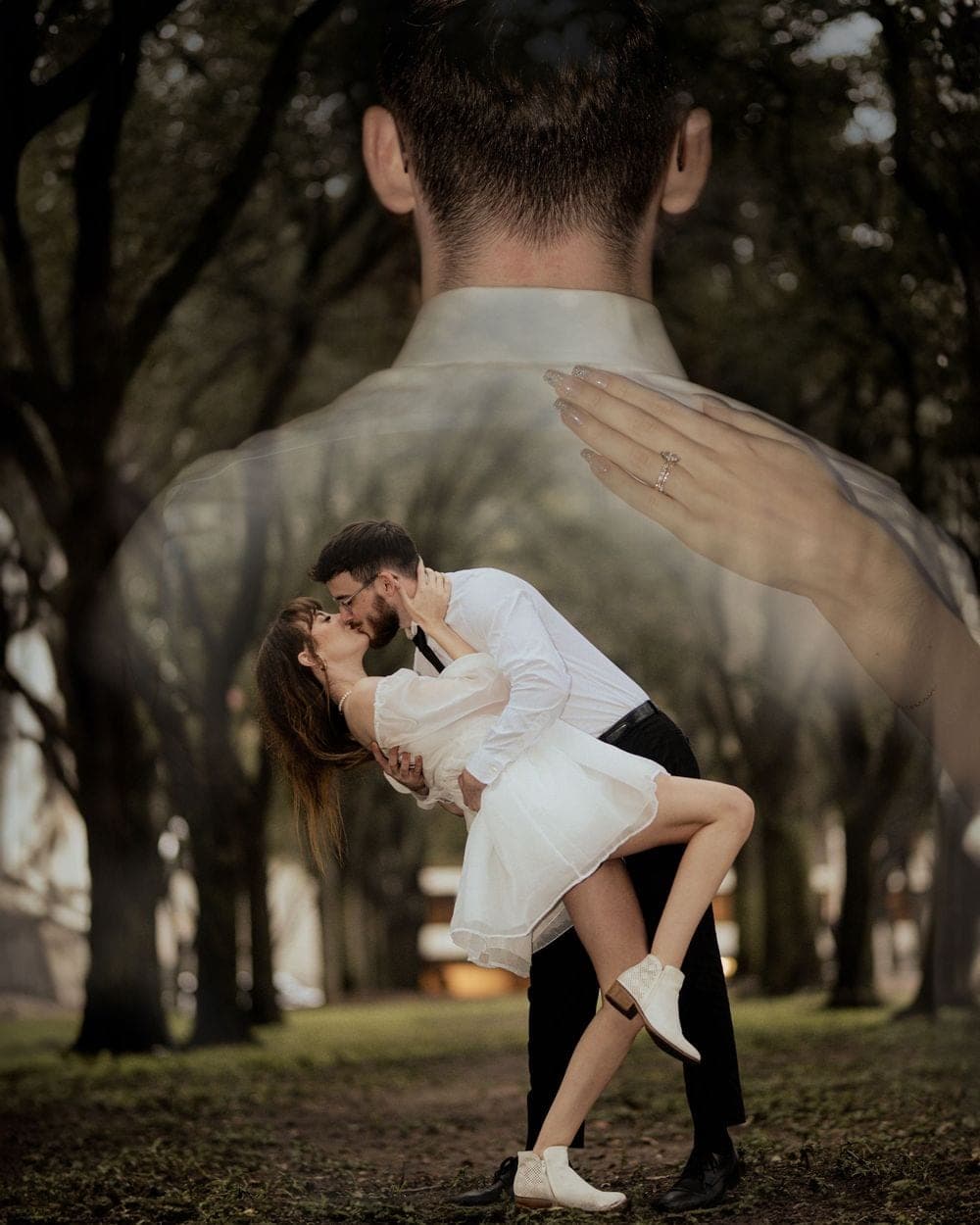 A groom dipping the bride in an avenue of trees